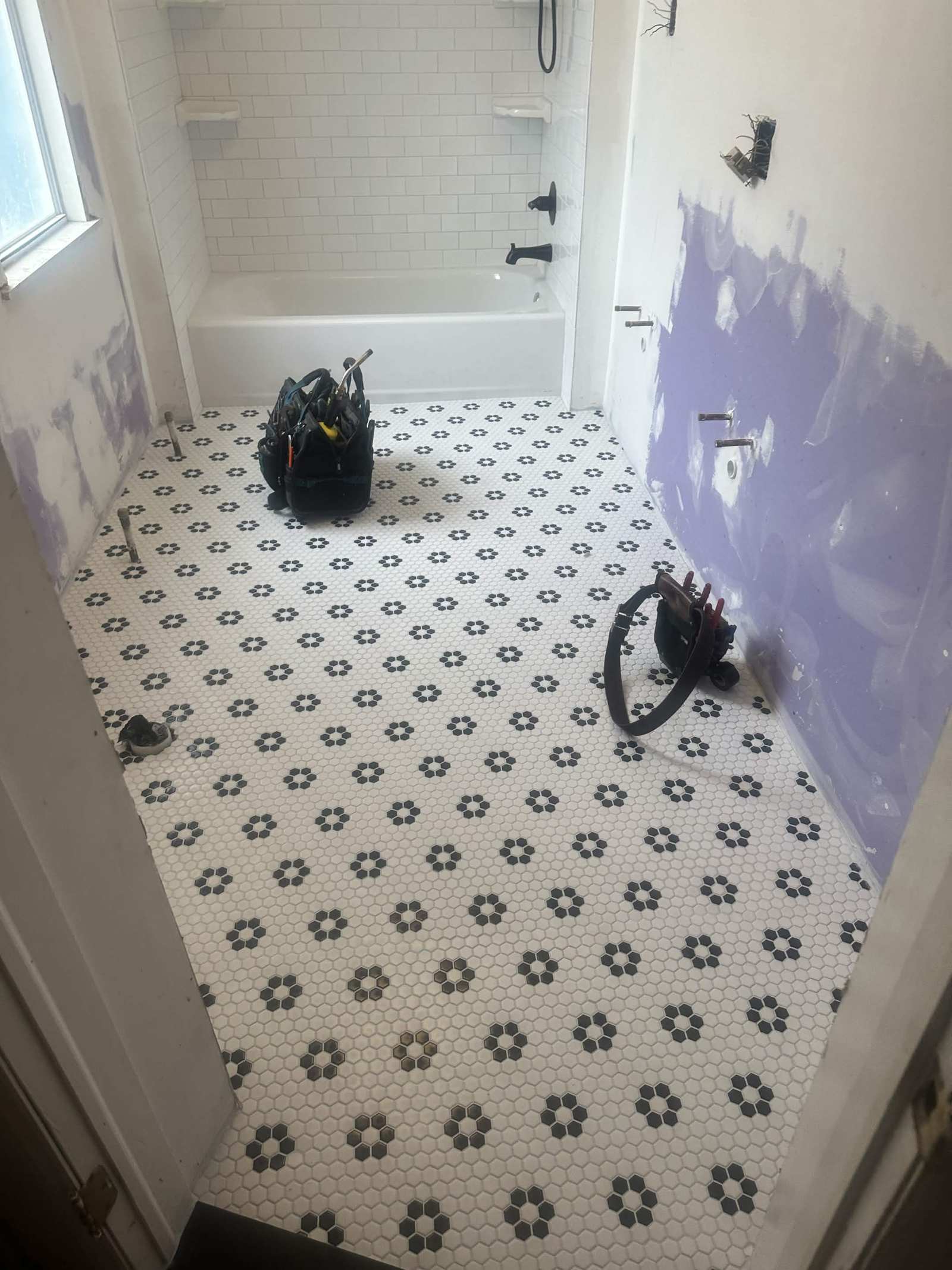 New hexagon tile floor installed during a bathroom remodel.