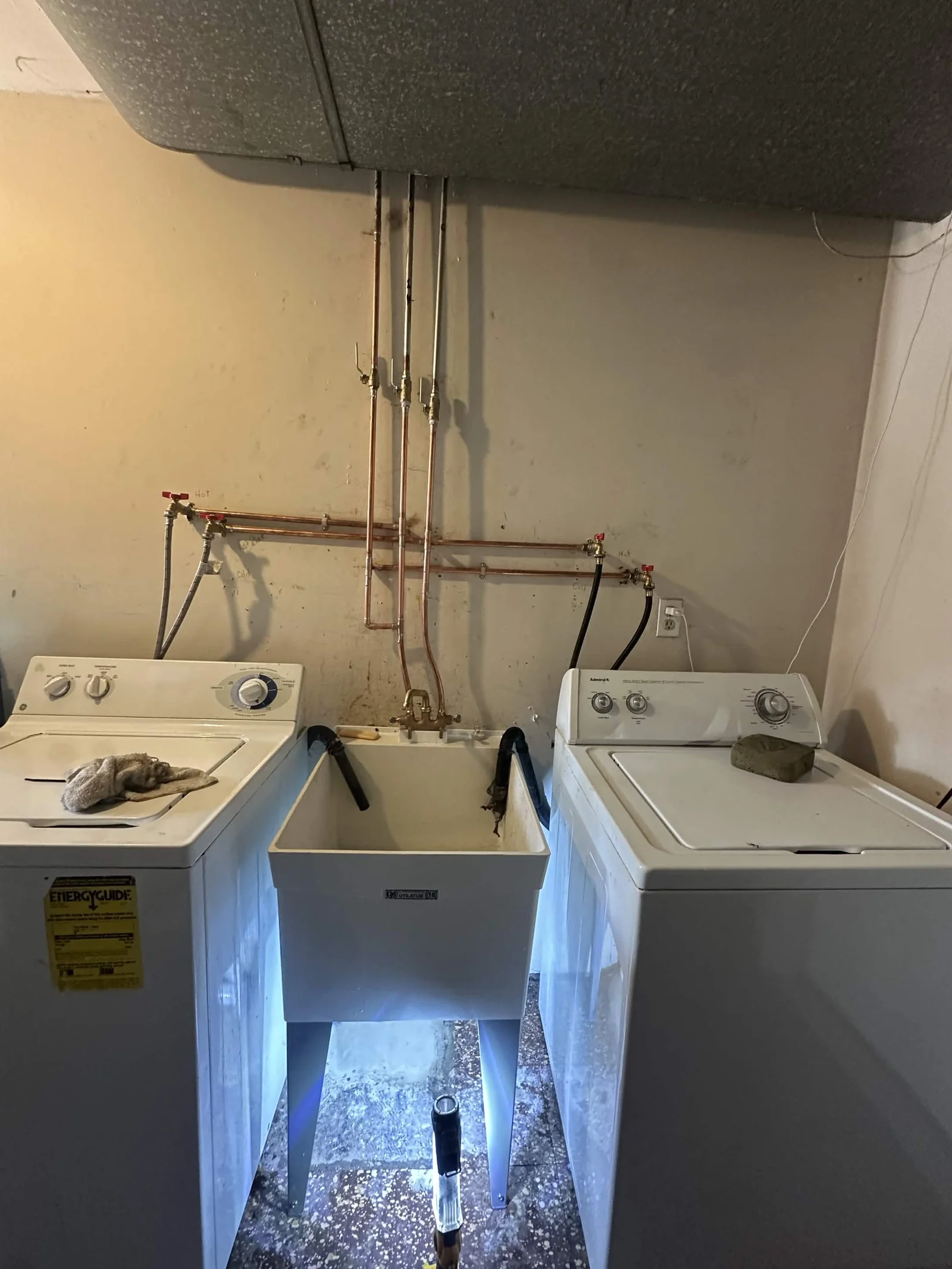 Copper water lines serving a laundry sink and washing machines.
